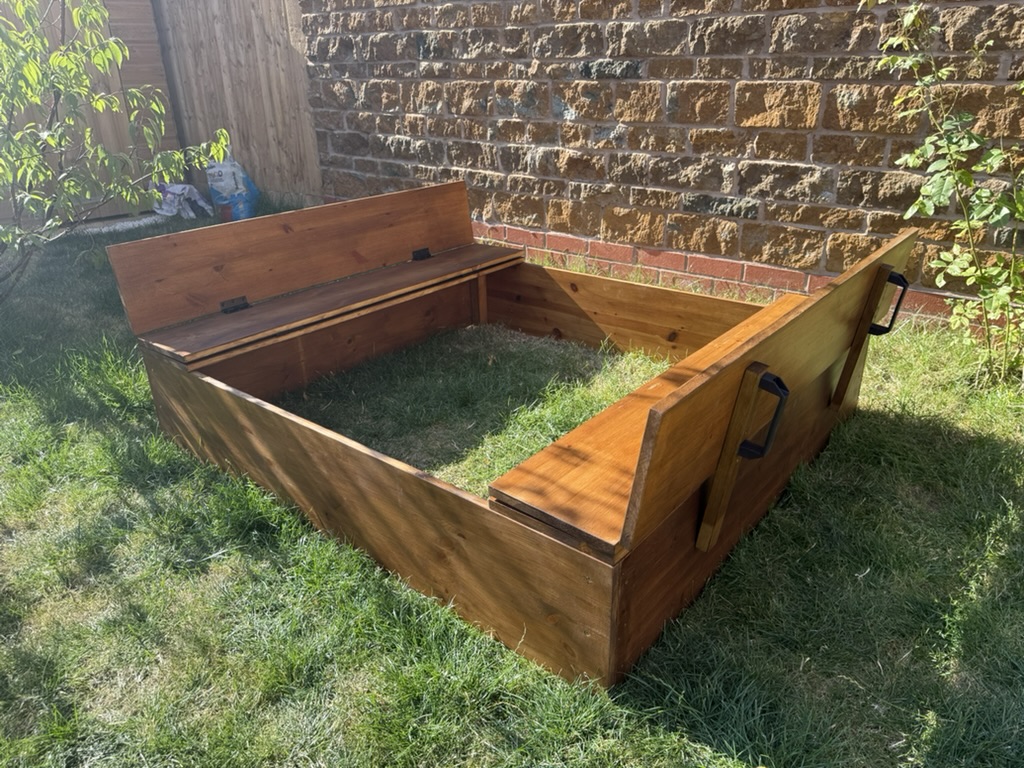 Handmade wooden children's sandpit with folding seats